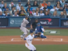 Left flips over woman wearing maga hat behind home plate during world series game