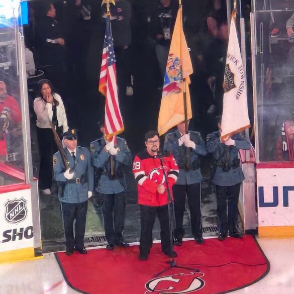 Brick township police honor guard presents colors at new jersey devils game - photo licensed by shore news network.