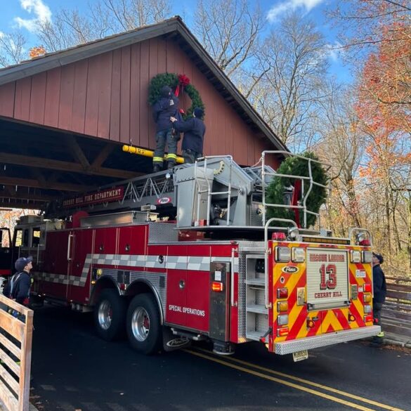 Cherry hill firefighters assist with annual wreath hanging at covered bridge - photo licensed by shore news network.
