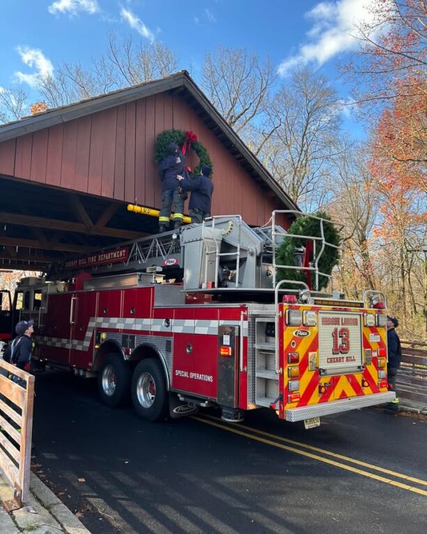 Cherry Hill firefighters assist with annual wreath hanging at Covered Bridge