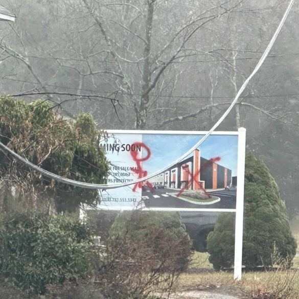 Vandal defaces warehouse construction sign with obscene graffiti in jackson - photo licensed by shore news network.