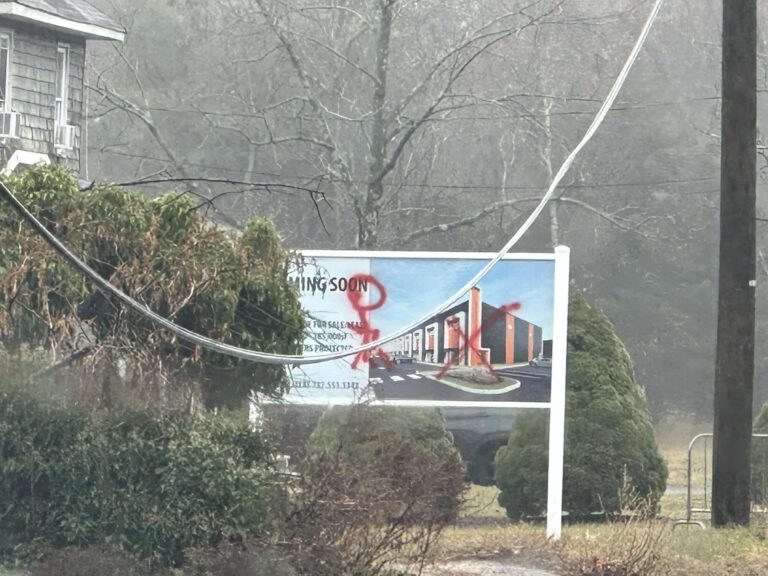 Vandal defaces warehouse construction sign with obscene graffiti in jackson - photo licensed by shore news network.