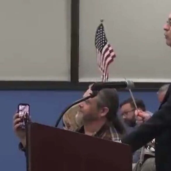 Lawyer from new jersey's top legislative democrat's firm spearheaded removal of citizen holding american flag at raritan town council meeting - photo licensed by shore news network.