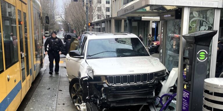 Reckless driver in stolen jeep crashes into portland streetcar stop, nearly hitting pedestrians - photo licensed by shore news network.
