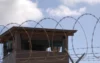GUANTANAMO BAY, CUBA 12.31.2009 Photo by Spc. Cody Black U.S. Navy Subscribe304 facebook sharing buttontwitter sharing buttonlinkedin sharing buttonsharethis sharing button A Soldier stands guard in a tower at Camp Delta at Joint Task Force Guantanamo Bay. (U.S. Army photo by Spc. Cody Black)