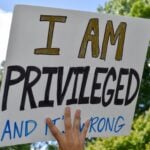 A High School Student Holding Up A Sign That Says I Am Privileged And It`s Wrong To Support Black Lives. Westfield, NJ: 06/07/20: A High School Student Holding Up A Sign That Says I Am Privileged And It`s Wrong To Support The Black Lives Matter Movement At A Protest For George Floyd`s Death.
