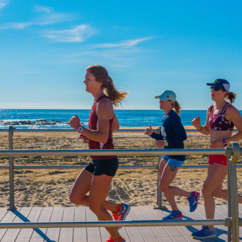 Women jogging on the boardwalk.