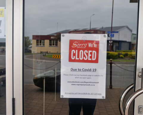 A sign in a window of a business shutdown during the COVID-19 pandemic