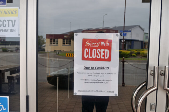A sign in a window of a business shutdown during the COVID-19 pandemic