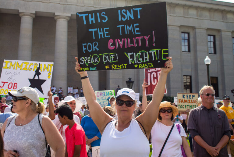Ice protester in los angeles absolutely wrecked by nfl quality tackle by innocent bystander - photo licensed by shore news network.