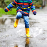 A child playing in the rain - File Photo