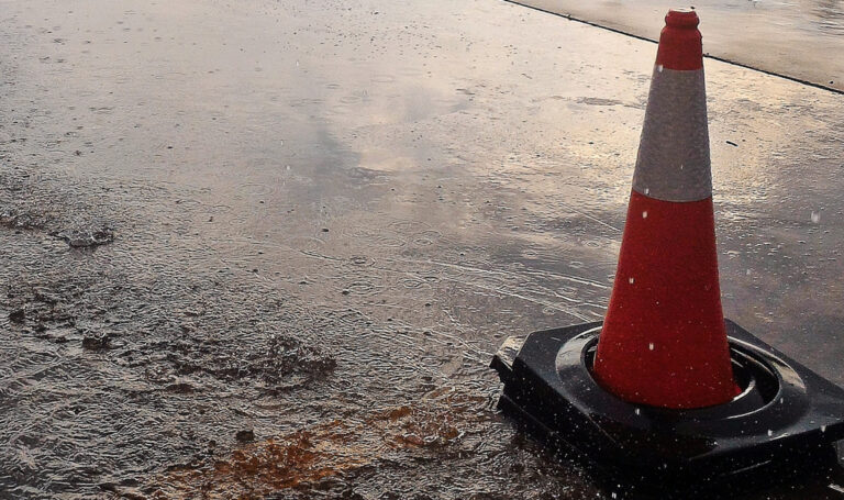 Traffic cone in flooded road