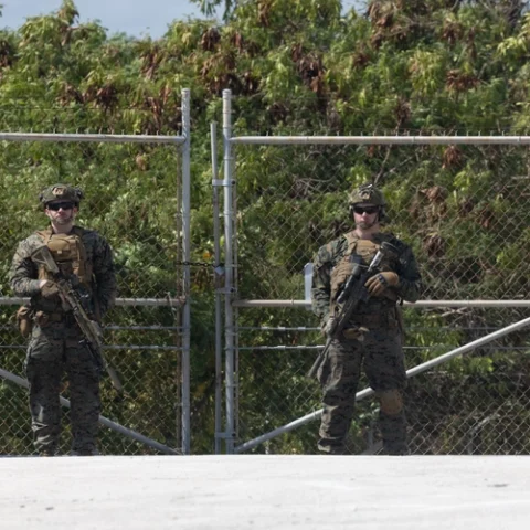 U. S. Marines guarding a temporary migrant holding facility.
