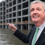 Phil Murphy pointing at a flooded building - AI / Photoshop enhanced political satire
