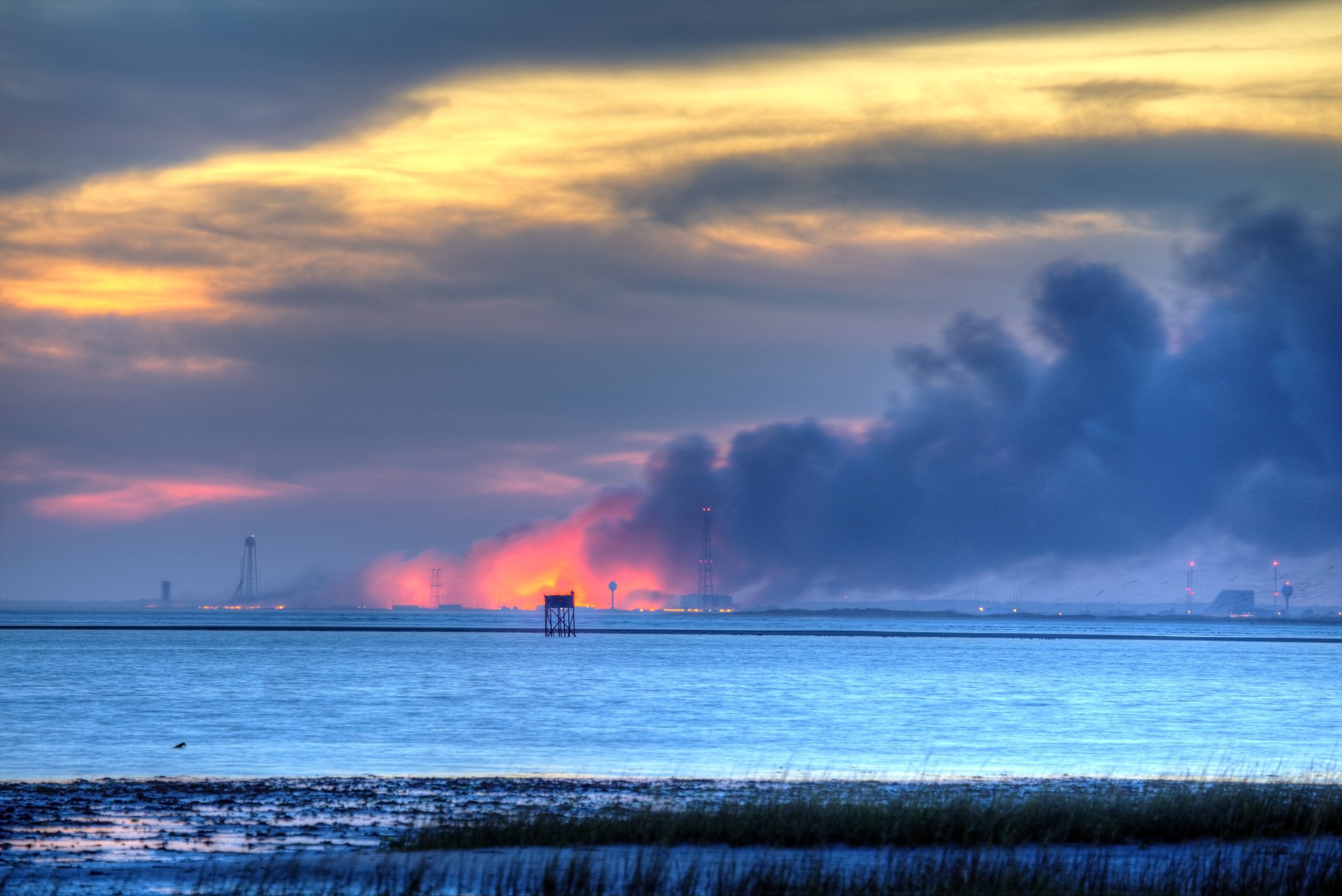 An Antares rocket burns on the launch pad at NASA s Wallops Flight Facility. An Orbital Sciences Corp.