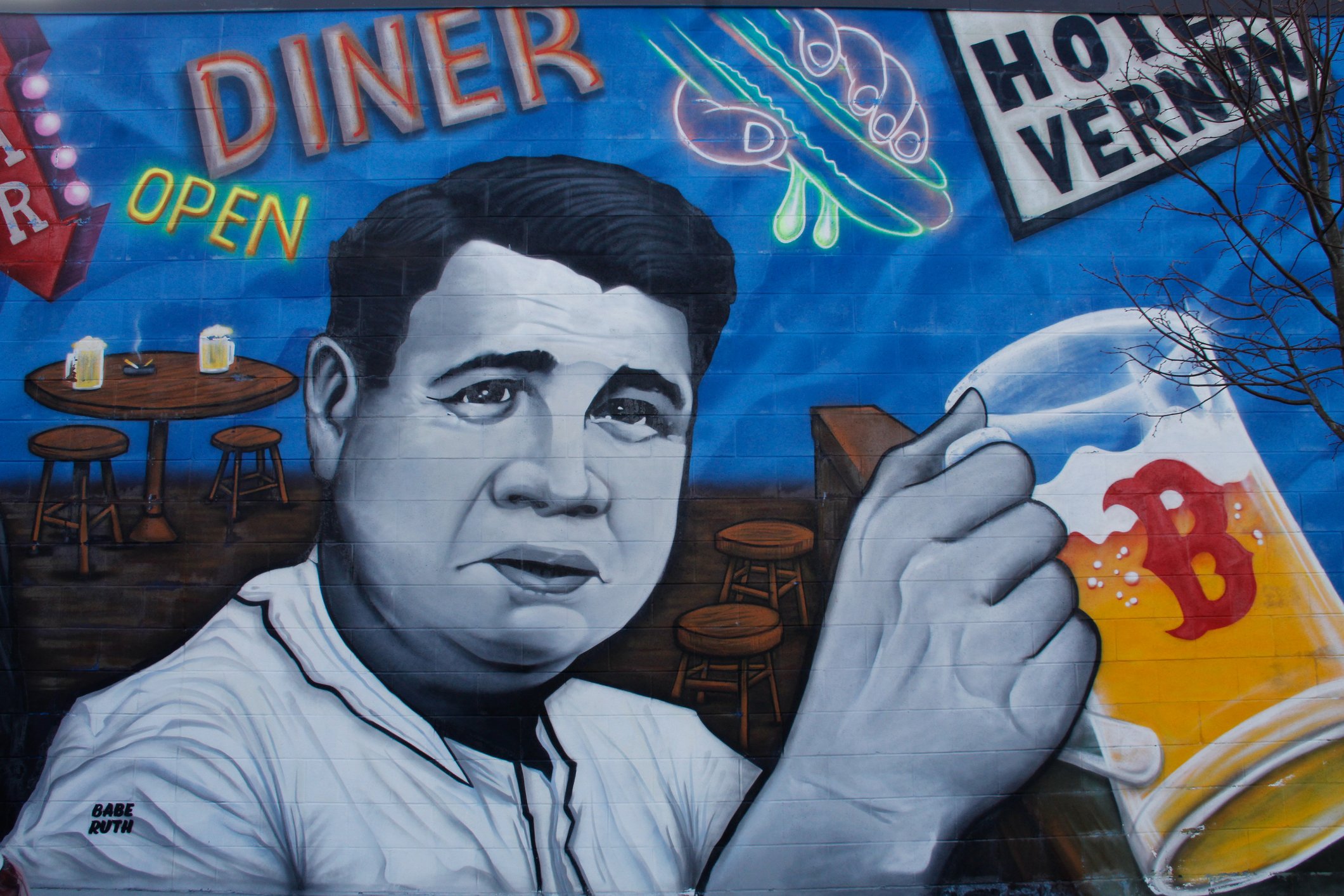 BABE RUTH RED SOX BALLPLAYER DISPLAYED ON WALL OUTSIDE POLAR PARK WORCESTER, hotel verone. Babe Ruth red sox ball player displayed drinking a beer with red sox logo, on wall at POlar park ballfield, hotel vernon, one of babe ruths stops coming through worcester