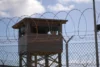A soldier stands guard in a tower at Camp Delta, Joint Task Force Guantanamo Bay, Cuba, Dec. 31, 2009. U.S. Army photo by Spc. Cody Black