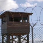 A soldier stands guard in a tower at Camp Delta, Joint Task Force Guantanamo Bay, Cuba, Dec. 31, 2009. U.S. Army photo by Spc. Cody Black