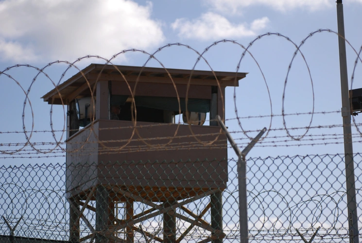 A soldier stands guard in a tower at Camp Delta, Joint Task Force Guantanamo Bay, Cuba, Dec. 31, 2009. U.S. Army photo by Spc. Cody Black
