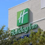 Holiday inn sign against blue sky