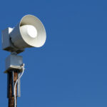 Loudspeaker mounted on utility pole.
