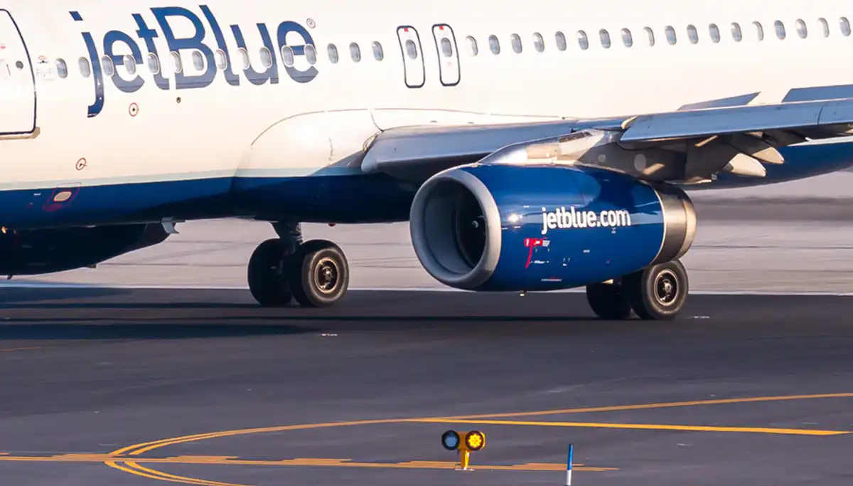 Engine issue forces emergency landing at newark airport; passengers use slide to exit plane - photo licensed by shore news network.