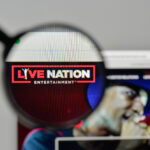 Magnifying glass focusing on the Live Nation Entertainment logo on a computer screen.