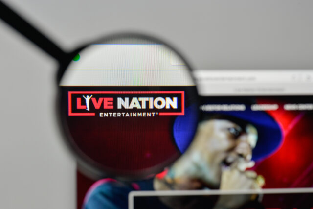 Magnifying glass focusing on the live nation entertainment logo on a computer screen.