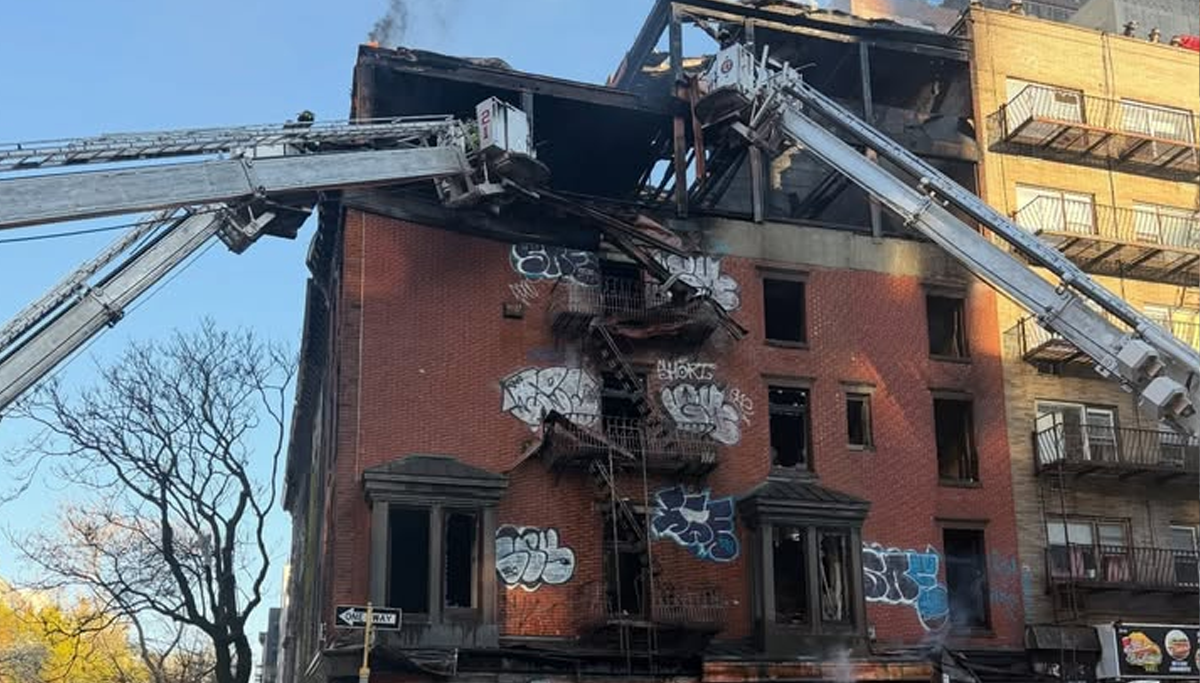 Two firefighters were injured as crews battled a three-alarm fire in a vacant Manhattan building early Sunday
