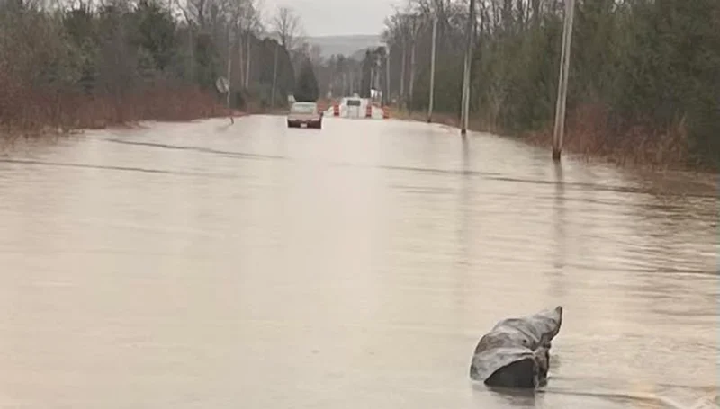 Flooded road rescue in cortland after driver ignores barriers, gets stuck