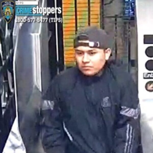 Surveillance image of a man in a black jacket and backward cap inside a store; crime stoppers overlay with phone number 800-577-8477 visible.