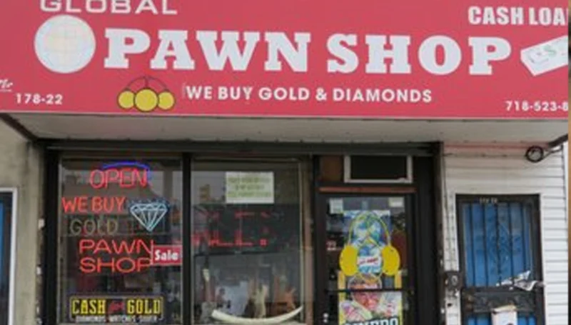 Global pawn shop storefront with a bright red sign reading 'global pawn shop' and 'we buy gold & diamonds' above the entrance; neon 'open' sign in the window.