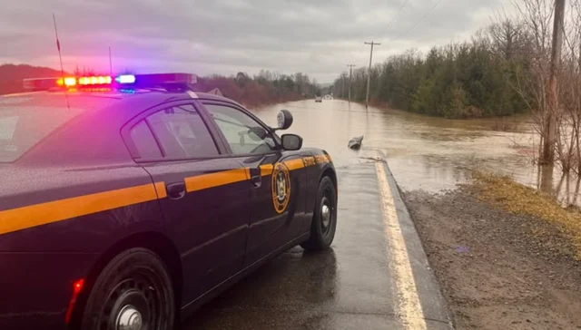 Flooded road rescue in cortland after driver ignores barriers, gets stuck