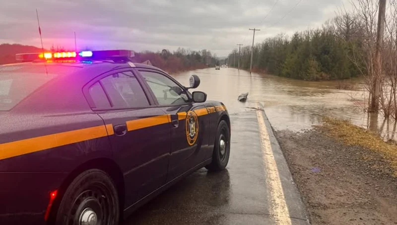 Flooded road rescue in cortland after driver ignores barriers, gets stuck
