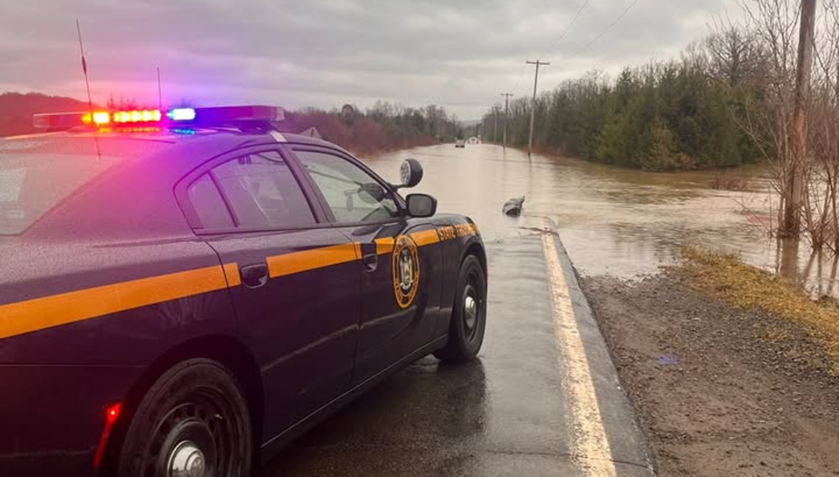 Flooded road rescue in cortland after driver ignores barriers, gets stuck