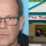 Mugshot of a middle‑aged man with glasses next to a storefront labeled 'The Soup Kitchen'.