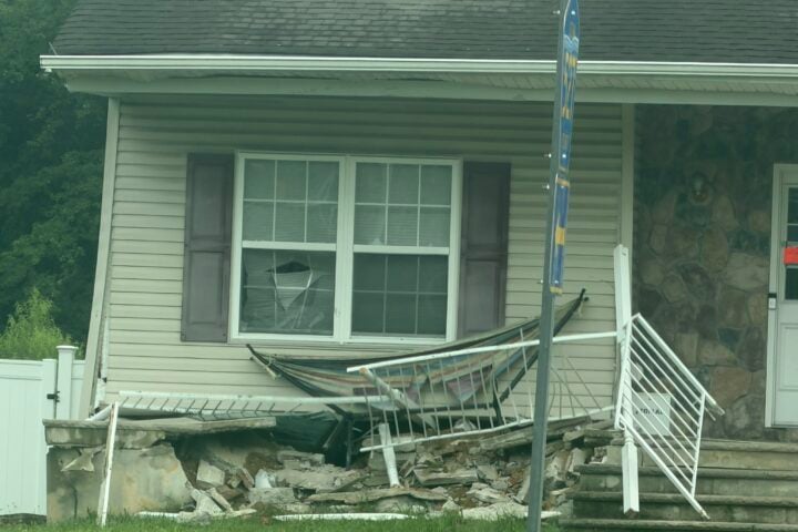 A coach bus traveling northbound crashed into a home at the busy T-intersection of East Veterans Highway (Ocean County Route 528) and Whitesville Road early Wednesday morning after apparently continuing straight through the intersection.