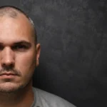 A Baltimore police officer faces six charges after Harford County investigators say DNA linked him to the on-duty rape of a woman in Edgewood.
