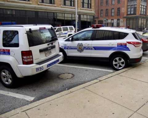 Baltimore,Maryland police vehicles. City police cars outside Baltimore police headquaters - by Kevin Duke