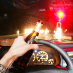 Drunk. Drinking beer whileDrunk. Drinking beer while driving car driving car. Photo by Ghubo Amin
