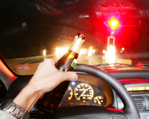 Drunk. Drinking beer whileDrunk. Drinking beer while driving car driving car. Photo by Ghubo Amin