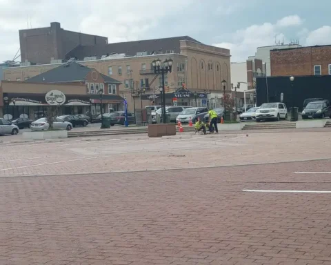 Photo caption: Nw parking spaces being striped at the former Lakewood Town Square, replacing much of the historic public gathering space near Clifton Avenue and 3rd Street.