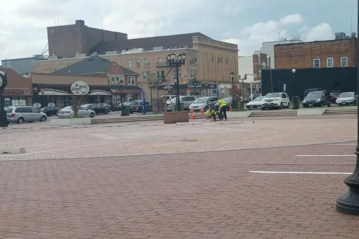 Photo caption: Nw parking spaces being striped at the former Lakewood Town Square, replacing much of the historic public gathering space near Clifton Avenue and 3rd Street.