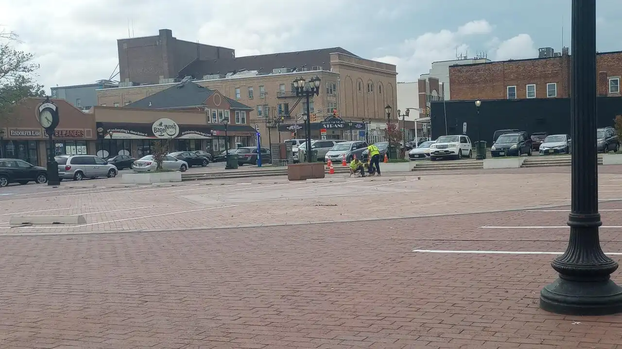 Photo caption: nw parking spaces being striped at the former lakewood town square, replacing much of the historic public gathering space near clifton avenue and 3rd street.