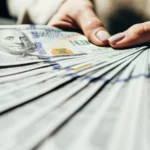 Woman holding hundreds of dollars from US lottery Winning