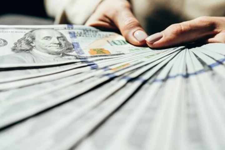 Woman holding hundreds of dollars from US lottery Winning