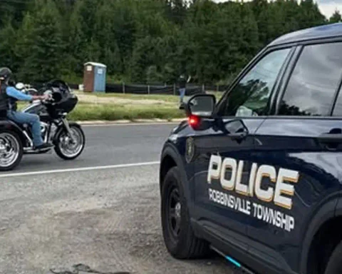 Photo Caption: Officers from the Robbinsville Township Police Department stand with participants in the America's 9/11 Remembrance Ride as the tribute event passed through Robbinsville on Saturday. Photo by Robbinsville Police Dept./Facebook