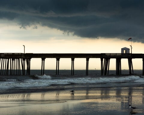 Shore point pier. Storm clouds hover over the fishing pier at Ocean City, NJ