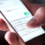 Man sending text on mobile phone - Photo Tero Vesalainen