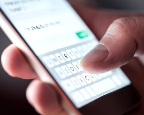 Man sending text on mobile phone - Photo Tero Vesalainen